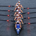 Female rowing team in the boat on the water